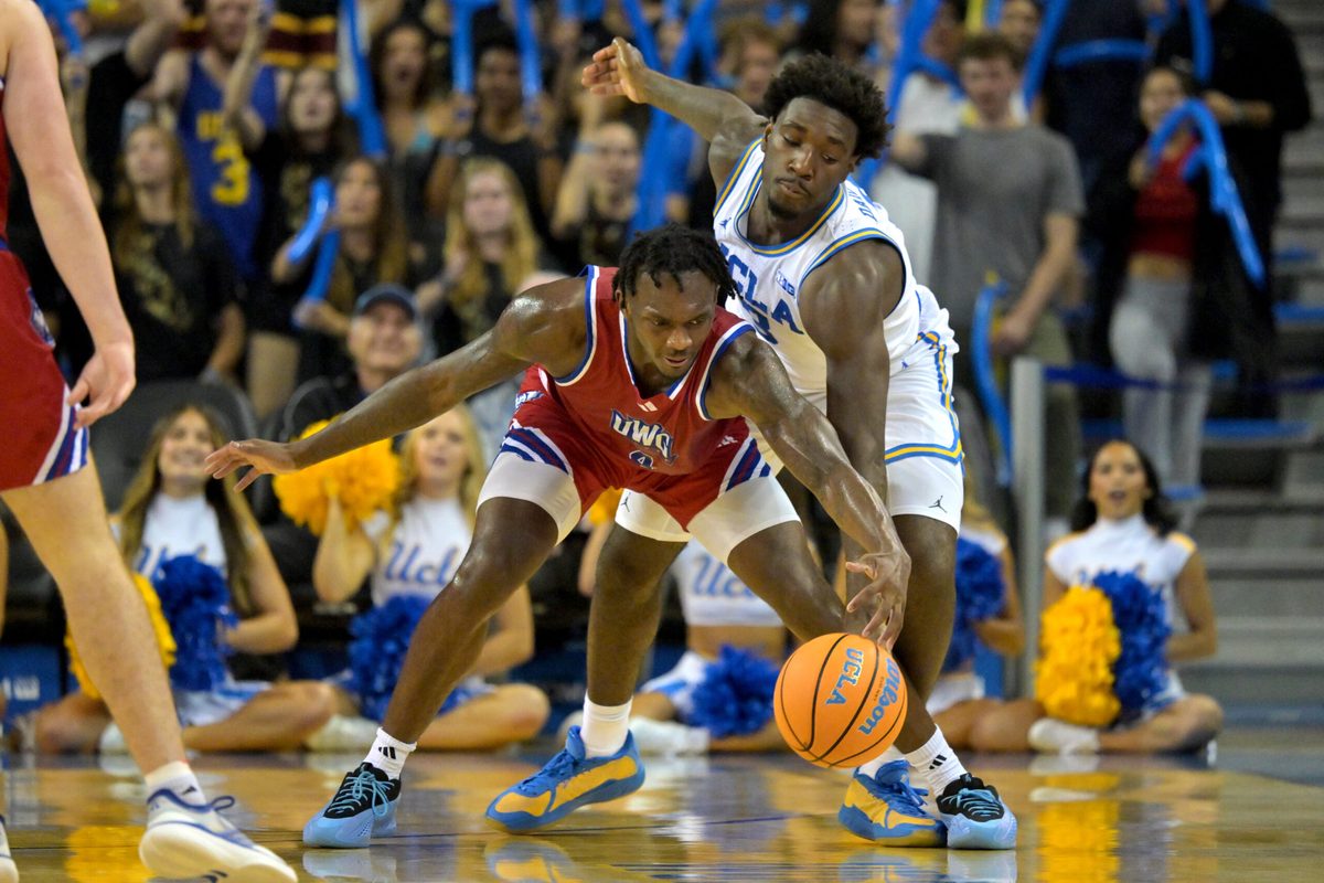 Nov 10, 2025; Los Angeles, California, USA; West Georgia Wolves forward Shelton Williams-Dryden (4) keeps the ball from UCLA Bruins forward Eric Dailey Jr. (3) during the second half at Pauley Pavilion presented by Wescom Financial. Mandatory Credit: Jayne Kamin-Oncea-Imagn Images