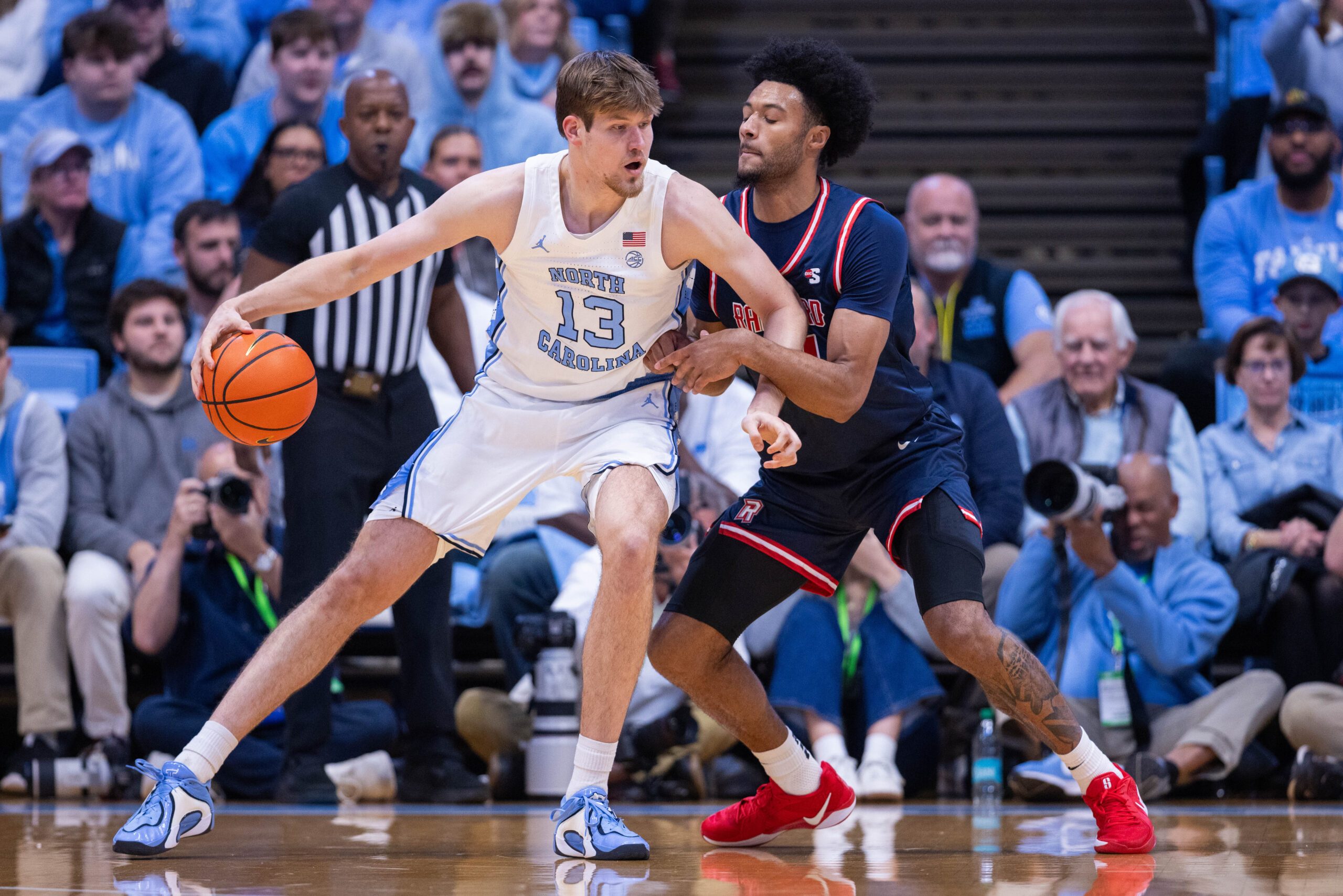 Nov 11, 2025; Chapel Hill, North Carolina, USA; North Carolina Tar Heels center Henri Veesaar (13) backs down on Radford Highlanders forward Tyson Brown (21) during the first half at Dean E. Smith Center. Mandatory Credit: Scott Kinser-Imagn Images