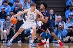 Nov 11, 2025; Chapel Hill, North Carolina, USA; North Carolina Tar Heels center Henri Veesaar (13) backs down on Radford Highlanders forward Tyson Brown (21) during the first half at Dean E. Smith Center. Mandatory Credit: Scott Kinser-Imagn Images