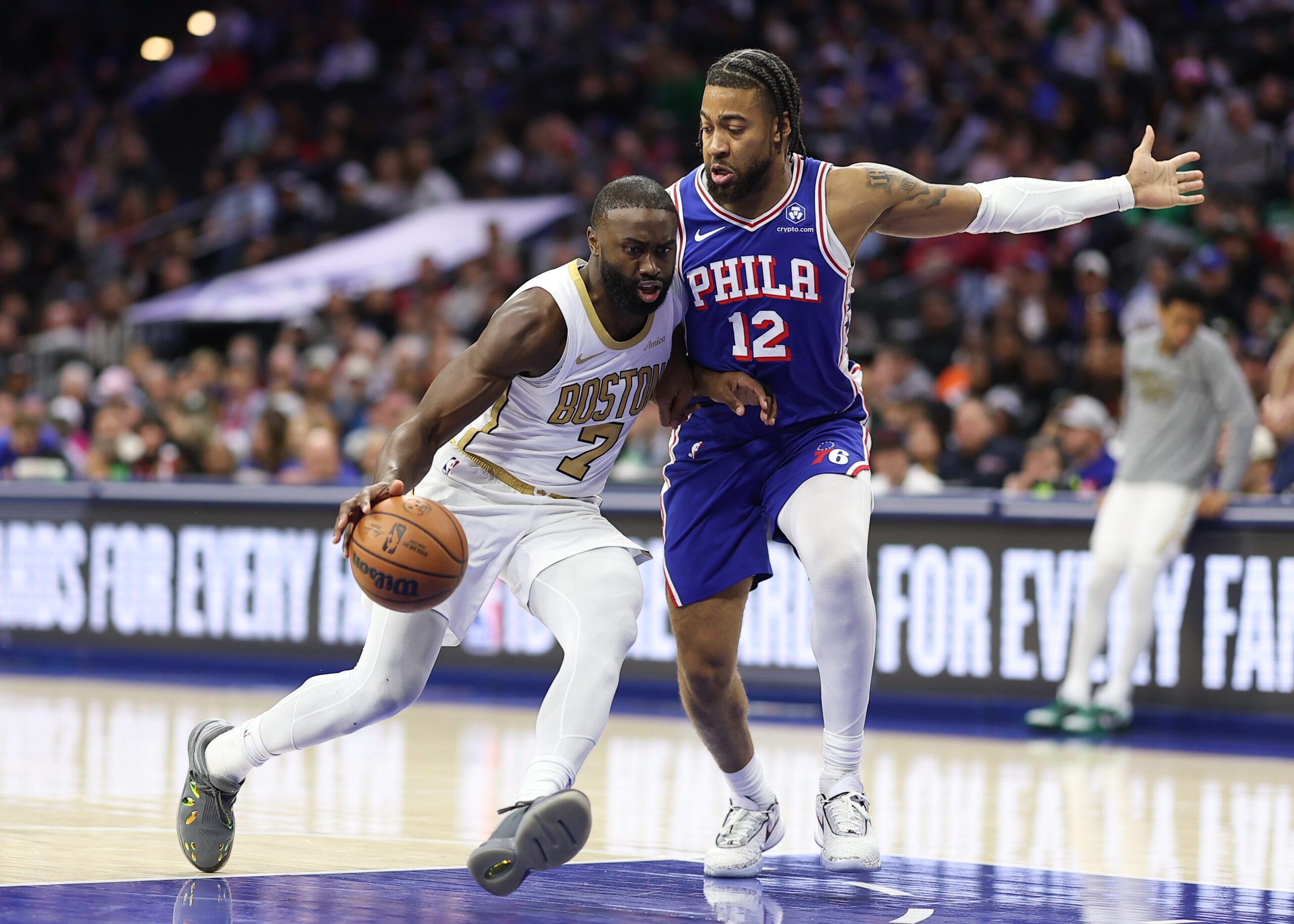 Nov 11, 2025; Philadelphia, Pennsylvania, USA; Boston Celtics guard Jaylen Brown (7) drives against Philadelphia 76ers forward Trendon Watford (12) during the second quarter at Xfinity Mobile Arena. Mandatory Credit: Bill Streicher-Imagn Images