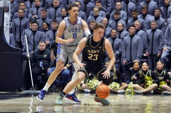 Nov 11, 2025; West Point, New York, USA; Army Black Knights forward Dylan Benner (23) is guarded by Duke Blue Devils guard/forward Darren Harris (8) during the second half at Christl Arena. Mandatory Credit: Danny Wild-Imagn Images