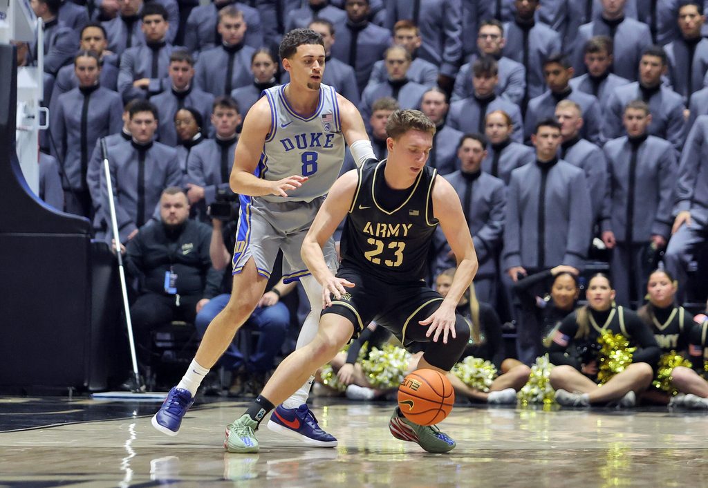 Nov 11, 2025; West Point, New York, USA; Army Black Knights forward Dylan Benner (23) is guarded by Duke Blue Devils guard/forward Darren Harris (8) during the second half at Christl Arena. Mandatory Credit: Danny Wild-Imagn Images