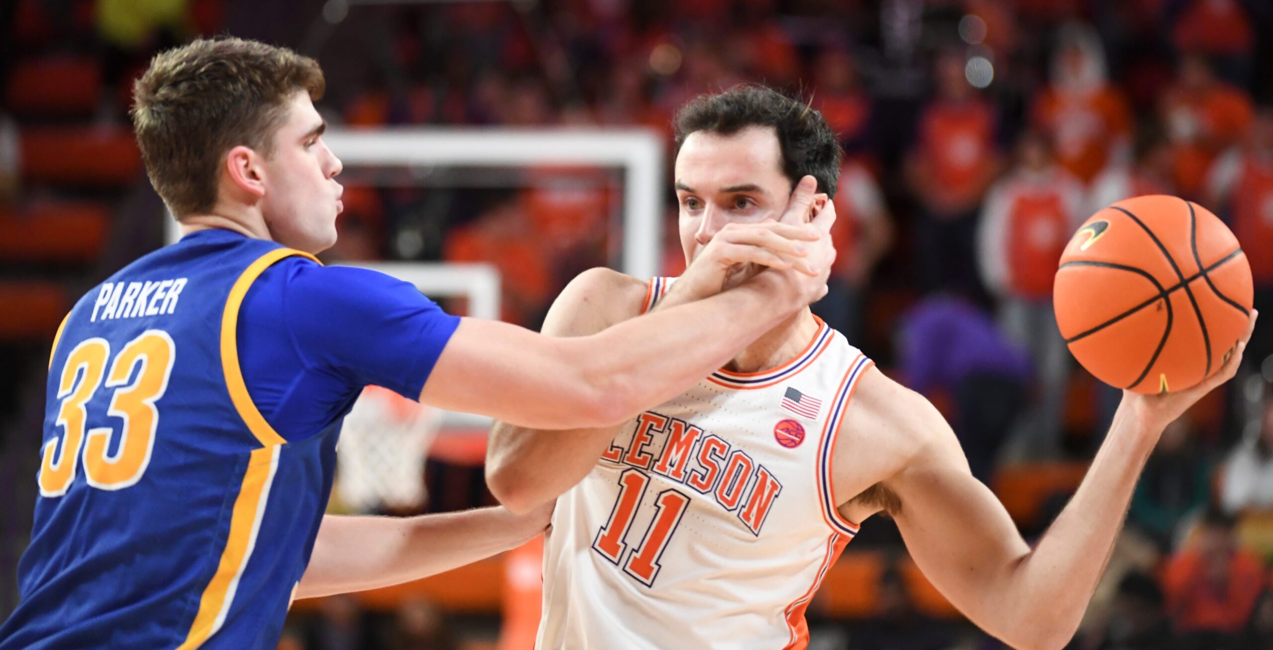 Morehead State Eagles forward Clayton Parker (33) defends Clemson Tigers forward Nick Davidson (11) Tuesday, Nov. 11, 2025, during the NCAA men’s basketball game at Littlejohn Coliseum in Clemson, South Carolina. Clemson Tigers won 83-56.