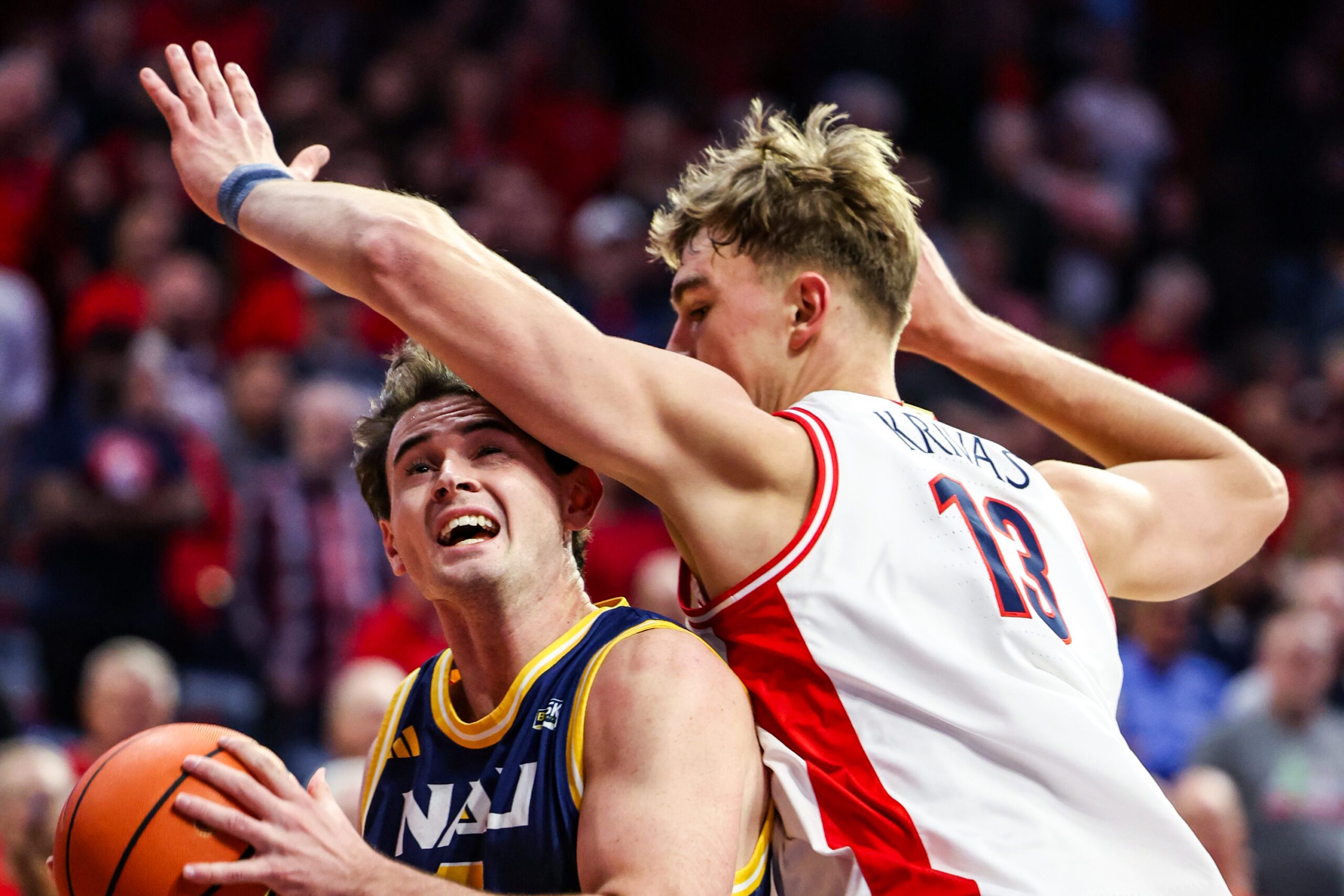 Nov 11, 2025; Tucson, Arizona, USA; Arizona Wildcats center Motiejus Krivas (13) fouls Northern Arizona Lumberjacks forward Zack Davidson (5) during the first half of the game at McKale Memorial Center. Mandatory Credit: Aryanna Frank-Imagn Images