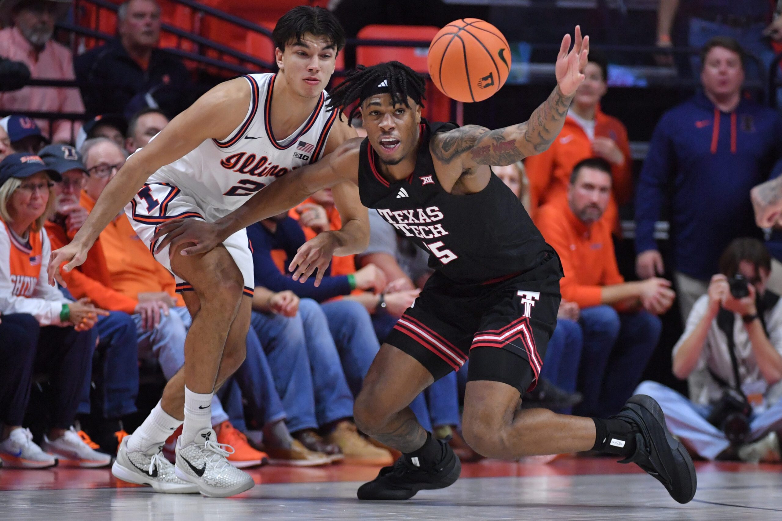 Nov 11, 2025; Champaign, Illinois, USA; Texas Tech Red Raiders forward JT Toppin (15) reaches for a loose ball in front of Illinois Fighting Illini guard Andrej Stojakovic (2) during the second half at State Farm Center. Mandatory Credit: Ron Johnson-Imagn Images