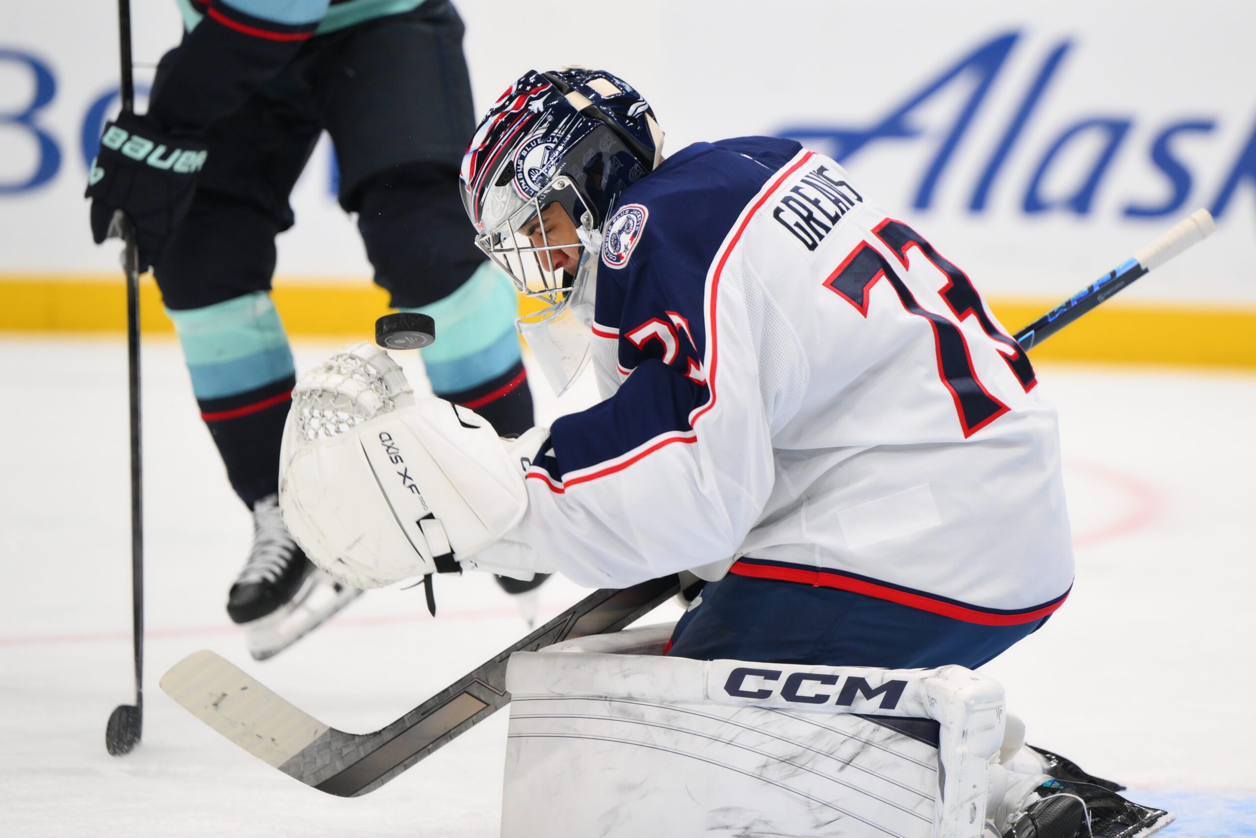 Nov 11, 2025; Seattle, Washington, USA; Columbus Blue Jackets goaltender Jet Greaves (73) blocks a Seattle Kraken goal shot during the second period at Climate Pledge Arena. Mandatory Credit: Steven Bisig-Imagn Images