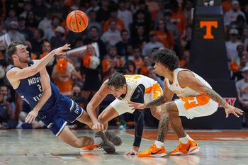 North Florida 's Mason Lee (2) throws the ball over Tennessee forward Cade Phillips (12) and Tennessee guard Ja'Kobi Gillespie (0) during a NCAA basketball game between Tennessee Volunteers and North Florida Ospreys at Thompson-Boling Arena at Food City Center in Knoxville, Tenn. on Nov. 12, 2025.