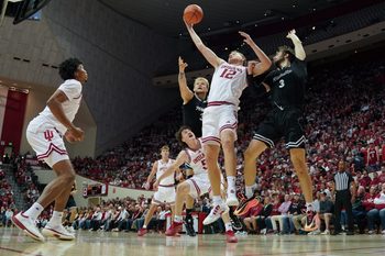 Nov 12, 2025; Bloomington, Indiana, USA; Indiana Hoosiers forward Tucker Devries (12) rebounds the ball against Milwaukee Panthers forward Danilo Jovanovich (3) during the second half at Simon Skjodt Assembly Hall. Mandatory Credit: Robert Goddin-Imagn Images