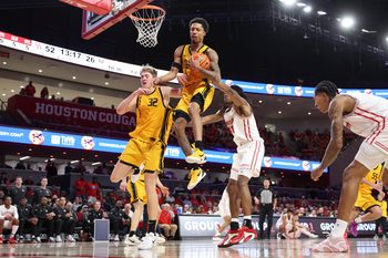 Nov 12, 2025; Houston, Texas, USA; Oakland Golden Grizzlies guard Ziare Wells (2) grabs a rebound during the second half against the Houston Cougars at Fertitta Center. Mandatory Credit: Troy Taormina-Imagn Images