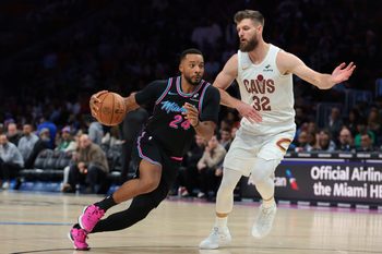 Nov 12, 2025; Miami, Florida, USA; Miami Heat guard Norman Powell (24) drives to the basket against Cleveland Cavaliers forward Dean Wade (32) during the third quarter at Kaseya Center. Mandatory Credit: Sam Navarro-Imagn Images
