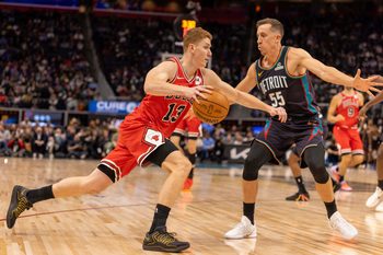 Nov 12, 2025; Detroit, Michigan, USA; Detroit Pistons forward Duncan Robinson (55) defends against Chicago Bulls guard Kevin Huerter (13) during the second half at Little Caesars Arena. Mandatory Credit: David Reginek-Imagn Images