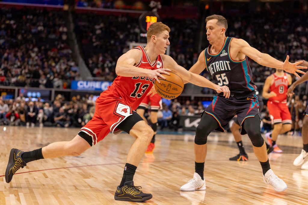 Nov 12, 2025; Detroit, Michigan, USA; Detroit Pistons forward Duncan Robinson (55) defends against Chicago Bulls guard Kevin Huerter (13) during the second half at Little Caesars Arena. Mandatory Credit: David Reginek-Imagn Images
