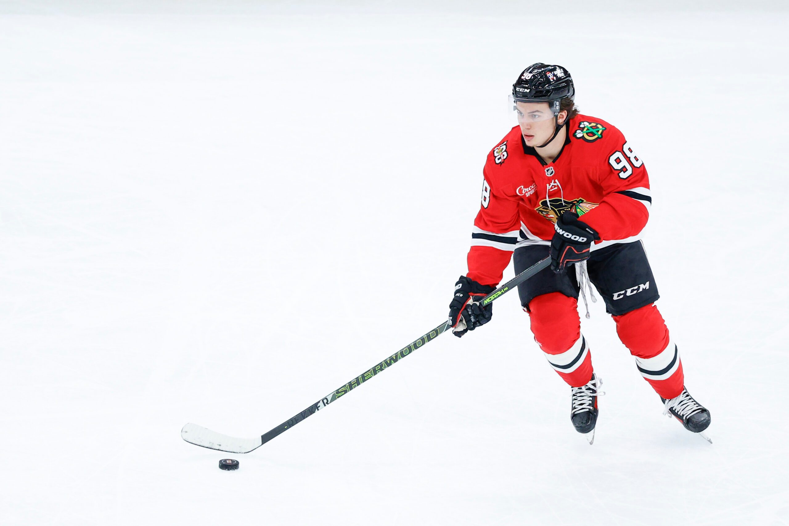 Nov 12, 2025; Chicago, Illinois, USA; Chicago Blackhawks center Connor Bedard (98) looks to pass the puck against the New Jersey Devils during the first period at United Center. Mandatory Credit: Kamil Krzaczynski-Imagn Images