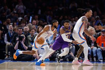 Nov 12, 2025; Oklahoma City, Oklahoma, USA; Oklahoma City Thunder guard Isaiah Joe (11) drives to the basket beside Los Angeles Lakers guard Marcus Smart (36) during the fourth quarter at Paycom Center. Mandatory Credit: Alonzo Adams-Imagn Images