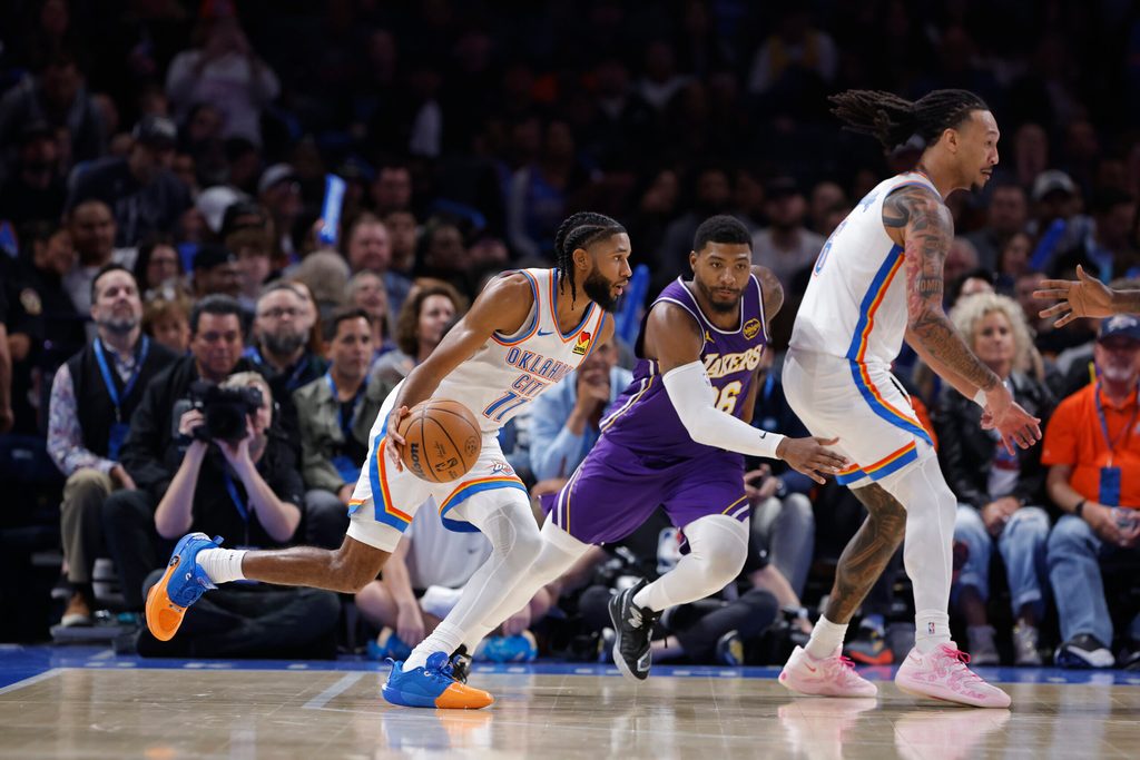 Nov 12, 2025; Oklahoma City, Oklahoma, USA; Oklahoma City Thunder guard Isaiah Joe (11) drives to the basket beside Los Angeles Lakers guard Marcus Smart (36) during the fourth quarter at Paycom Center. Mandatory Credit: Alonzo Adams-Imagn Images