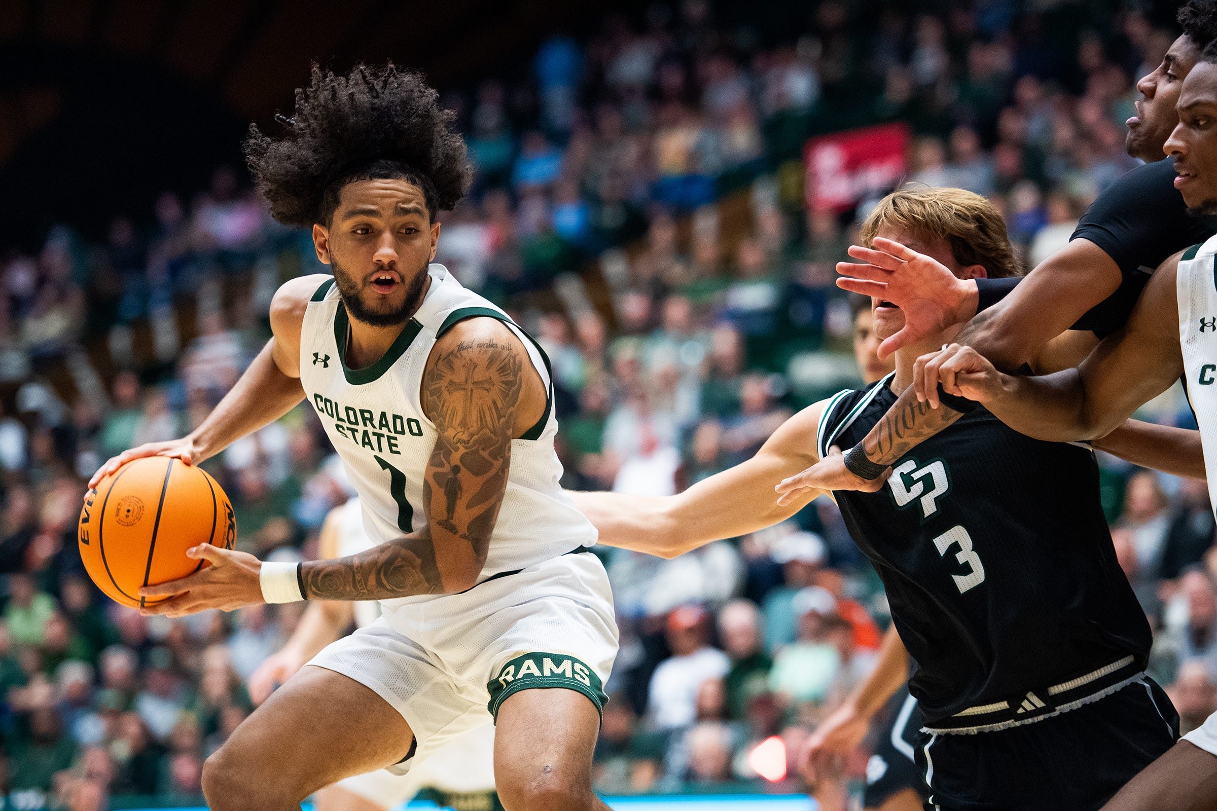 Colorado State's Josh Pascarelli gets around defenders during an NCAA Basketball game against Cal Poly at Moby Arena on Nov. 12, 2025 in Fort Collins, Colo.