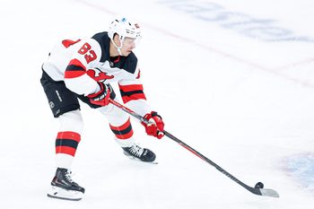 Nov 12, 2025; Chicago, Illinois, USA; New Jersey Devils left wing Jesper Bratt (63) controls the puck against the Chicago Blackhawks during the first period at United Center. Mandatory Credit: Kamil Krzaczynski-Imagn Images