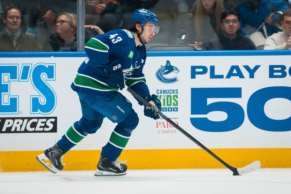 Nov 11, 2025; Vancouver, British Columbia, CAN; Vancouver Canucks defenseman Quinn Hughes (43) handles the puck against the Winnipeg Jets in the first period at Rogers Arena. Mandatory Credit: Bob Frid-Imagn Images