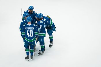Nov 11, 2025; Vancouver, British Columbia, CAN; Vancouver Canucks forward Evander Kane (91) and forward Conor Garland (8) and forward Elias Pettersson (40) and defenseman Quinn Hughes (43) and defenseman Filip Hronek (17) talk during a stop in play against the Winnipeg Jets in the third period at Rogers Arena. Mandatory Credit: Bob Frid-Imagn Images