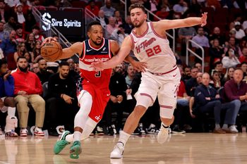 Nov 12, 2025; Houston, Texas, USA; Washington Wizards guard CJ McCollum (3) drives to the basket against Houston Rockets center Alperen Sengun (28) during the game at Toyota Center. Mandatory Credit: Erik Williams-Imagn Images