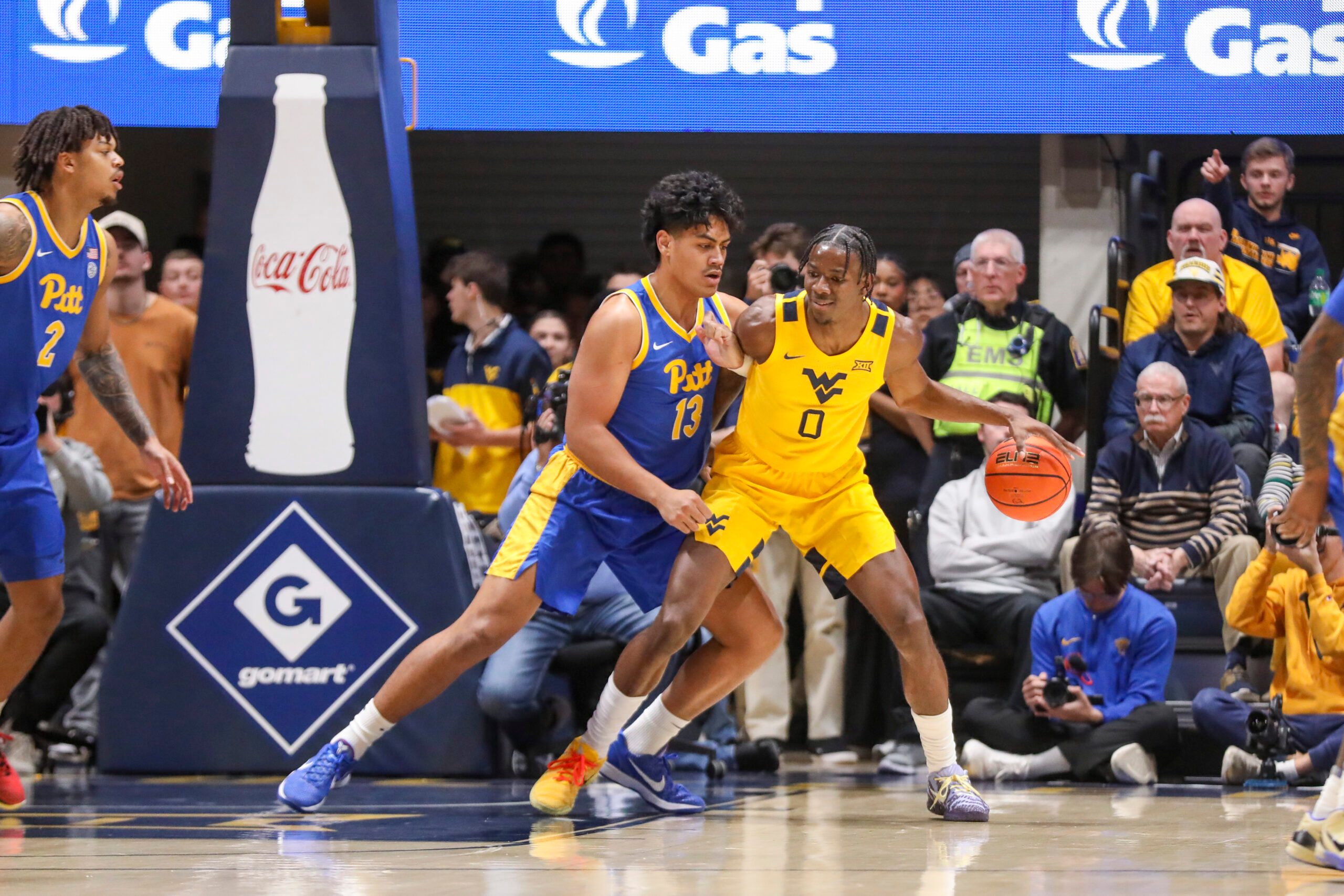 Nov 13, 2025; Morgantown, West Virginia, USA; West Virginia Mountaineers forward Brenen Lorient (0) dribbles against Pittsburgh Panthers forward Roman Siulepa (13) during the first half at WVU Coliseum. Mandatory Credit: Ben Queen-Imagn Images