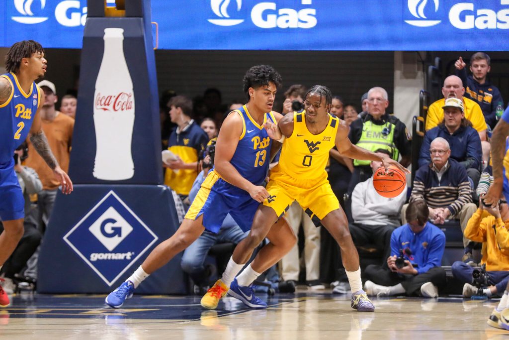 Nov 13, 2025; Morgantown, West Virginia, USA; West Virginia Mountaineers forward Brenen Lorient (0) dribbles against Pittsburgh Panthers forward Roman Siulepa (13) during the first half at WVU Coliseum. Mandatory Credit: Ben Queen-Imagn Images