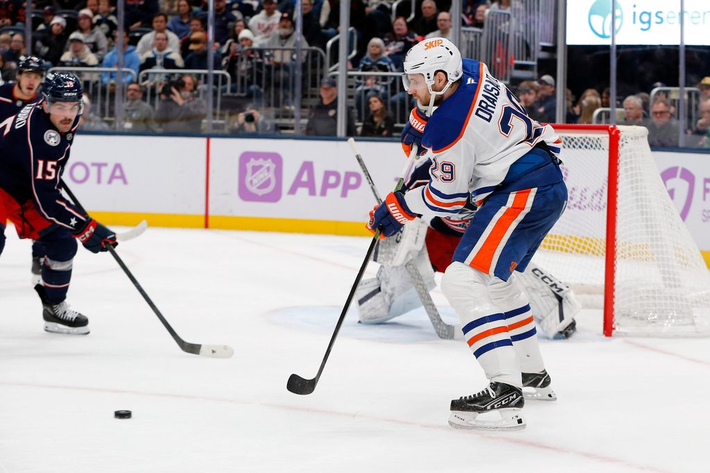 Nov 13, 2025; Columbus, Ohio, USA; Edmonton Oilers center Leon Draisaitl (29) receives a pass in front of Columbus Blue Jackets defenseman Dante Fabbro (15) during the first period at Nationwide Arena. Mandatory Credit: Russell LaBounty-Imagn Images