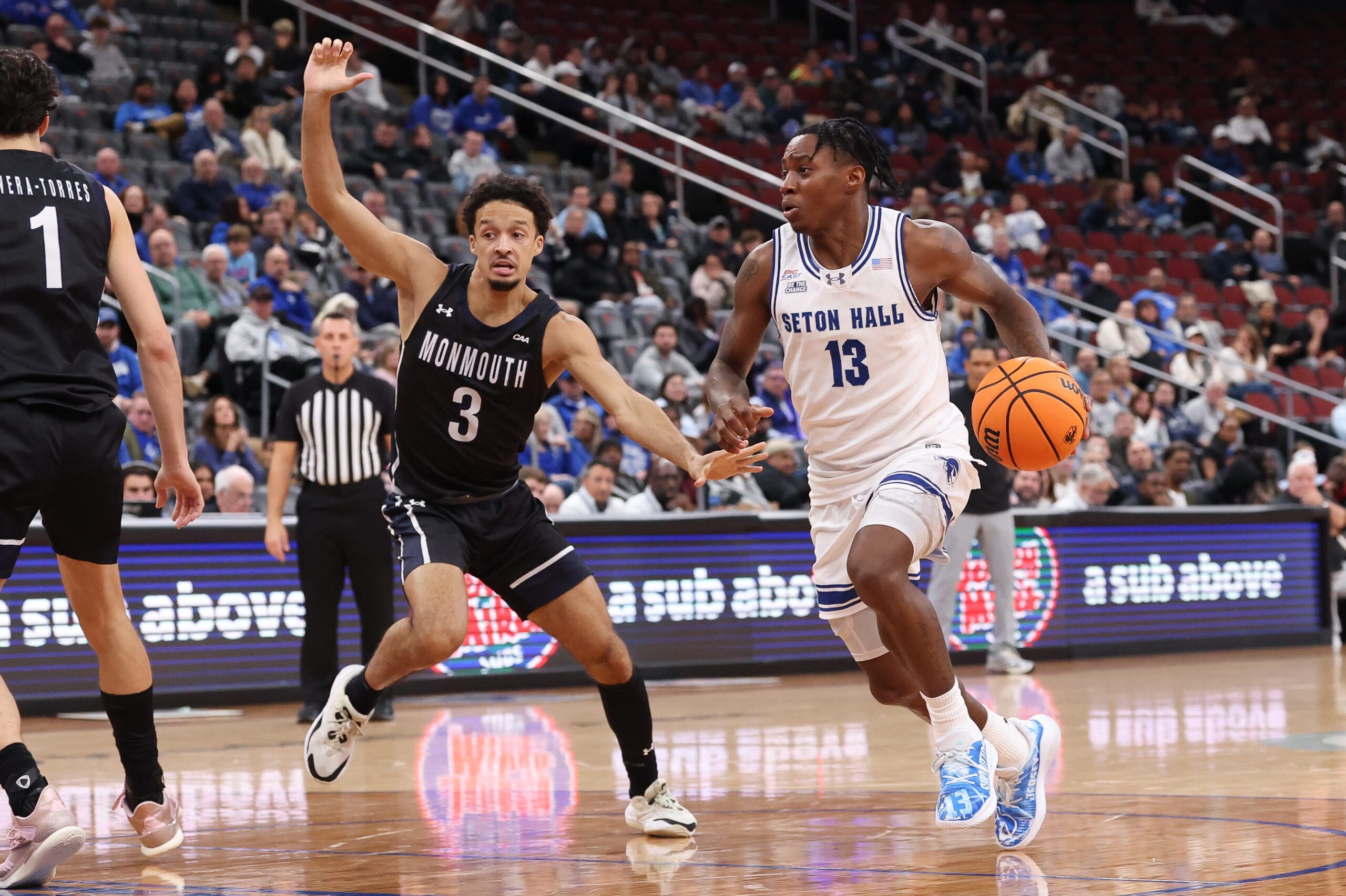 Nov 13, 2025; Newark, New Jersey, USA; Seton Hall Pirates guard Trey Parker (13) goes to the basket against Monmouth Fighting Scots guard Anthony Martinez (3) during the second half at Prudential Center. Mandatory Credit: Vincent Carchietta-Imagn Images
