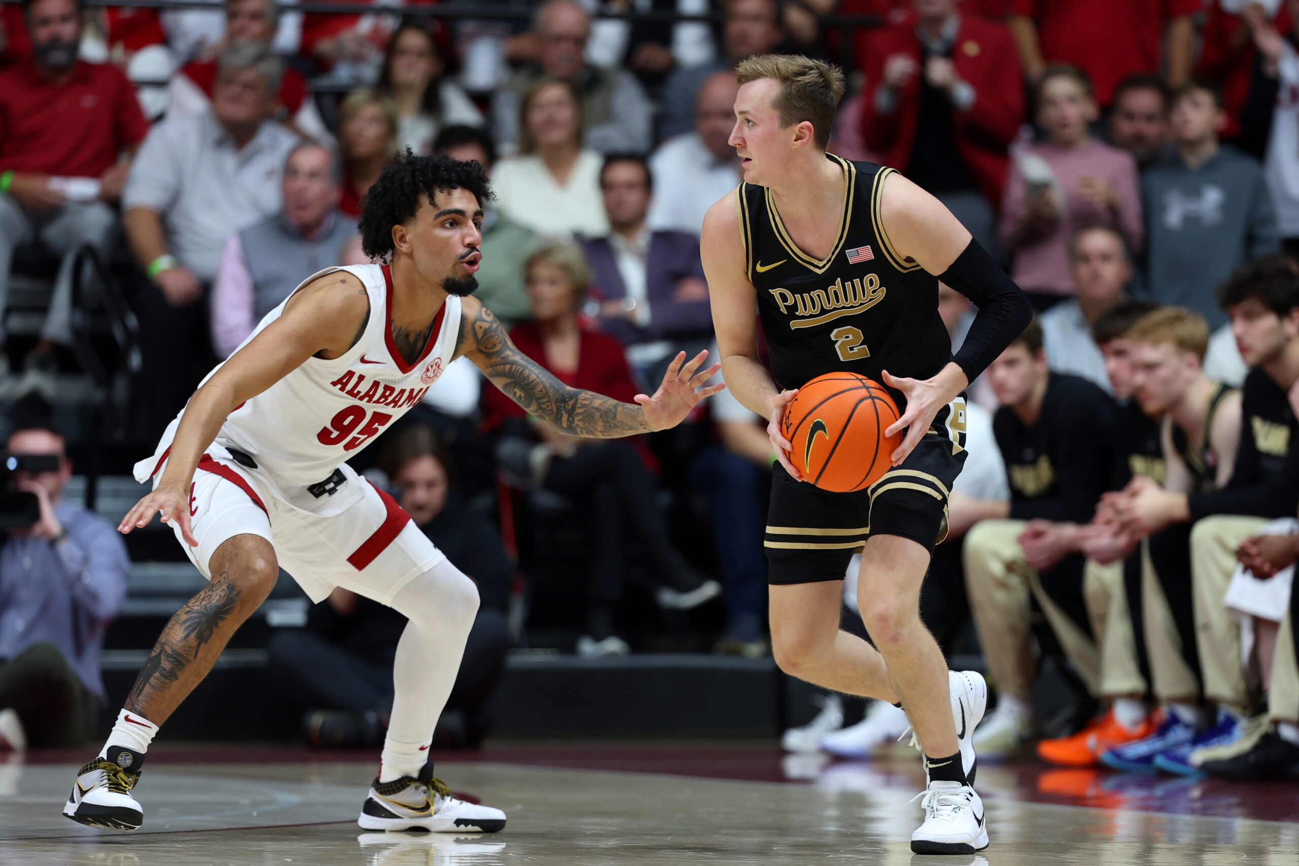 Nov 13, 2025; Tuscaloosa, Alabama, USA; Alabama Crimson Tide guard Houston Mallette (95) guards Purdue Boilermakers guard Fletcher Loyer (2) during the second half at Coleman Coliseum. Mandatory Credit: David Leong-Imagn Images
