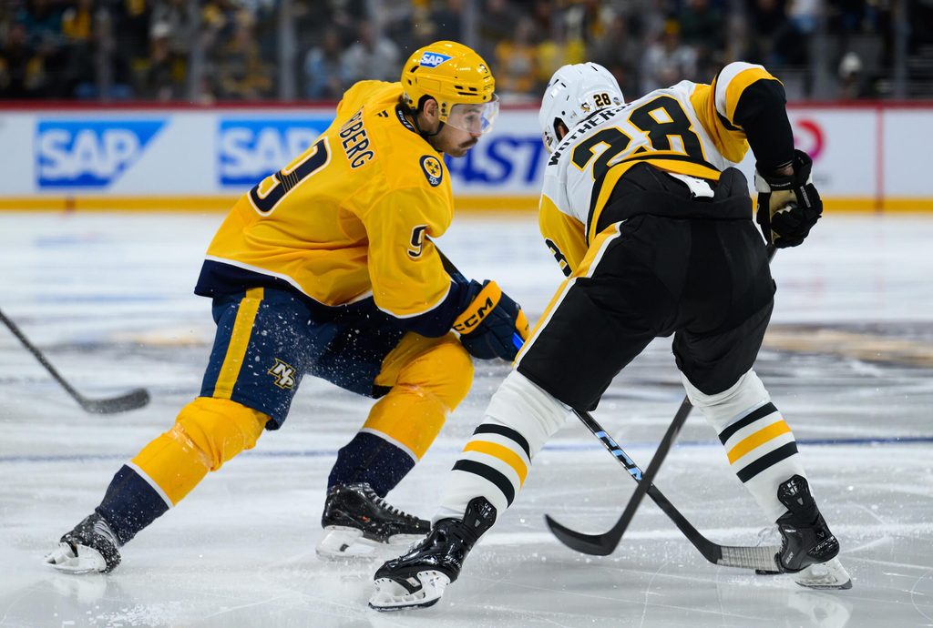Nov 14, 2025; Stockholm, SWEDEN; Nashville Predators left wing Filip Forsberg (9) skates with the puck against Pittsburgh Penguins defenseman Parker Wotherspoon (28) in a Global Series ice hockey game at Avicii Arena. Mandatory Credit: Per Haljestam-Imagn Images