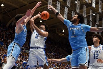 Nov 14, 2025; Durham, North Carolina, USA;  Duke Blue Devils guard Cayden Boozer (2) throws a pass in front of Indiana State Sycamores forward Ian Scott (23) and center Markus Harding (11) during the second half at Cameron Indoor Stadium. Mandatory Credit: Rob Kinnan-Imagn Images