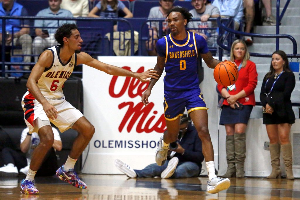 Nov 14, 2025; Oxford, Mississippi, USA; Cal State Bakersfield Roadrunners guard CJ Hardy (0) dribbles as Mississippi Rebels guard Ilias Kamardine (6) defends during the first half at C.M. ’Tad’ Smith Coliseum. Mandatory Credit: Petre Thomas-Imagn Images