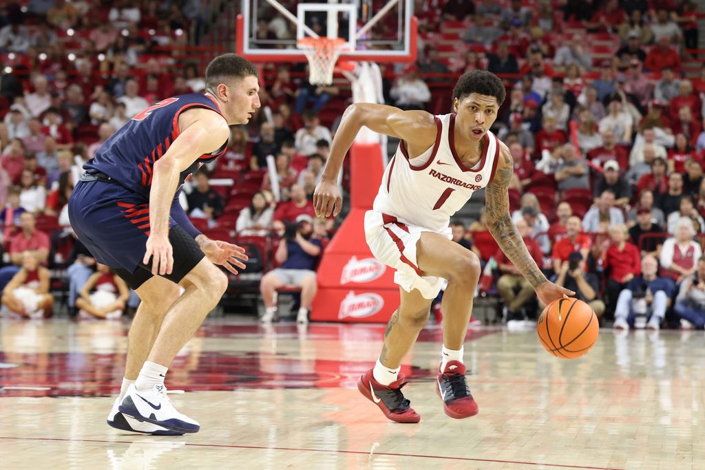Nov 14, 2025; Fayetteville, Arkansas, USA; Arkansas Razorbacks guard Meleek Thomas (1) drives against Samford Bulldogs guard Jadin Booth (2) during the second half at Bud Walton Arena. Arkansas won 79-75. Mandatory Credit: Nelson Chenault-Imagn Images