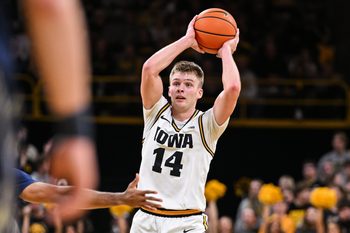 Nov 14, 2025; Iowa City, Iowa, USA; Iowa Hawkeyes guard Bennett Stirtz (14) looks to pass the ball during the second half against the Xavier Musketeers at Carver-Hawkeye Arena. Mandatory Credit: Jeffrey Becker-Imagn Images