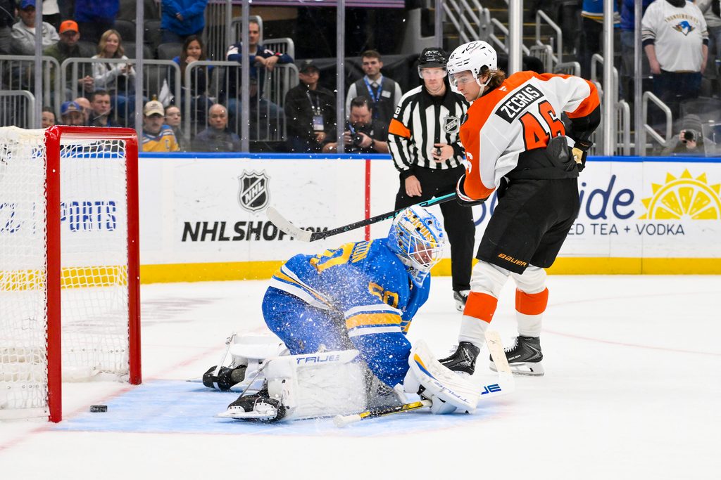 Nov 14, 2025; St. Louis, Missouri, USA; Philadelphia Flyers center Trevor Zegras (46) scores against St. Louis Blues goaltender Jordan Binnington (50) in shootouts at Enterprise Center. Mandatory Credit: Jeff Curry-Imagn Images