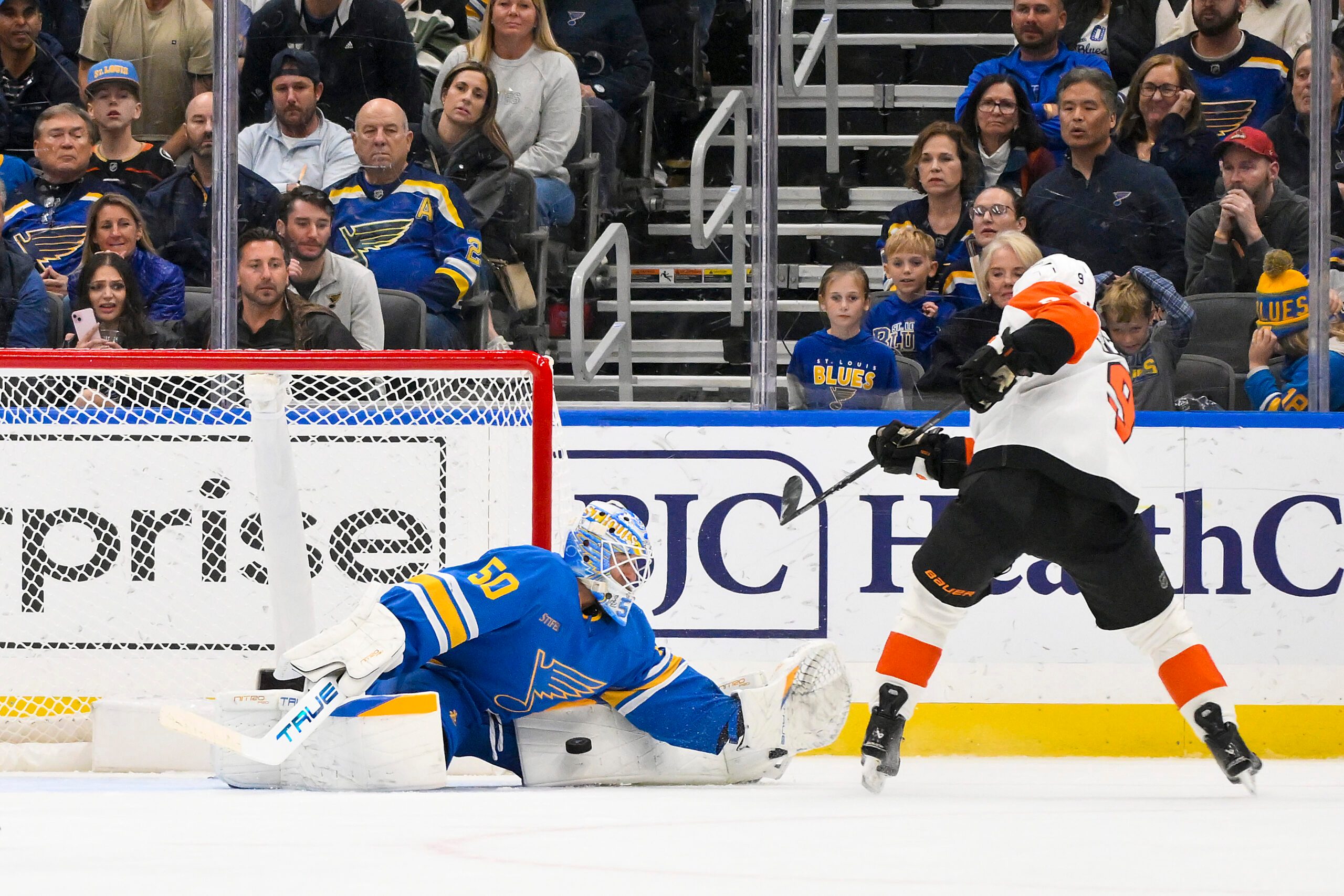 Nov 14, 2025; St. Louis, Missouri, USA; St. Louis Blues goaltender Jordan Binnington (50) makes a save against Philadelphia Flyers defenseman Jamie Drysdale (9) during overtime at Enterprise Center. Mandatory Credit: Jeff Curry-Imagn Images