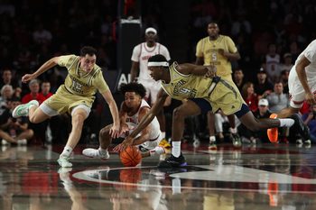 Nov 14, 2025; Athens, Georgia, USA; Georgia Bulldogs guard Jordan Ross (3) reaches for the ball against Georgia Tech Yellow Jackets guard Kam Craft (12) and Georgia Tech Yellow Jackets forward Kowacie Reeves Jr. (14) during the second half at Stegeman Coliseum. Mandatory Credit: Mady Mertens-Imagn Images