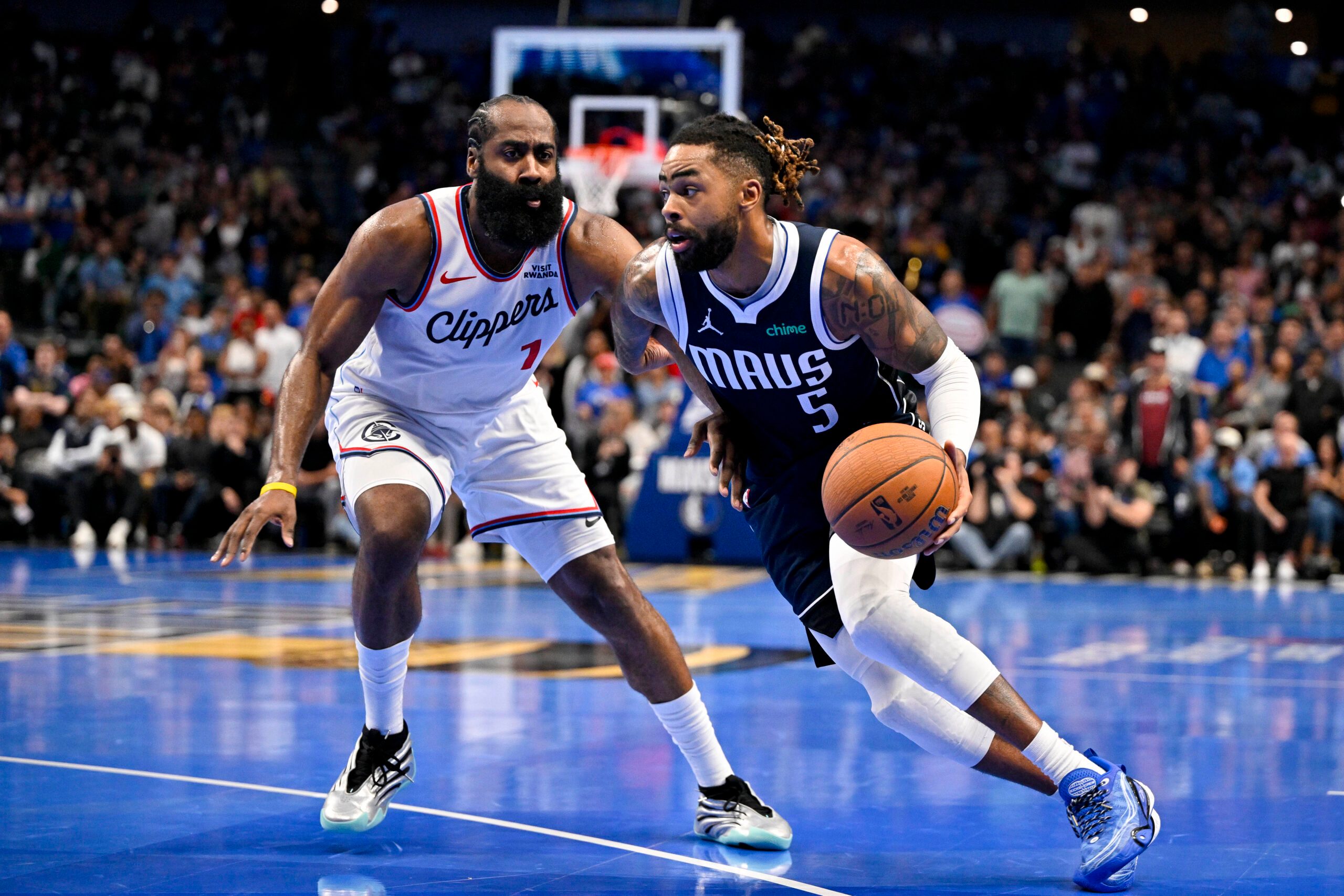 Nov 14, 2025; Dallas, Texas, USA; Dallas Mavericks guard D'Angelo Russell (5) drives to the basket past LA Clippers guard James Harden (1) during the second half in an NBA Cup game at the American Airlines Center. Mandatory Credit: Jerome Miron-Imagn Images