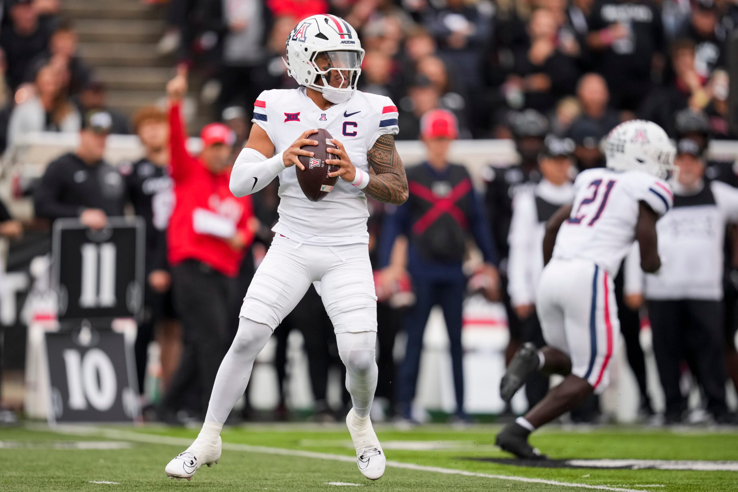 Nov 15, 2025; Cincinnati, Ohio, USA;  Arizona Wildcats quarterback Noah Fifita (1) drops back to pass against the Cincinnati Bearcats in the first half at Nippert Stadium. Mandatory Credit: Aaron Doster-Imagn Images