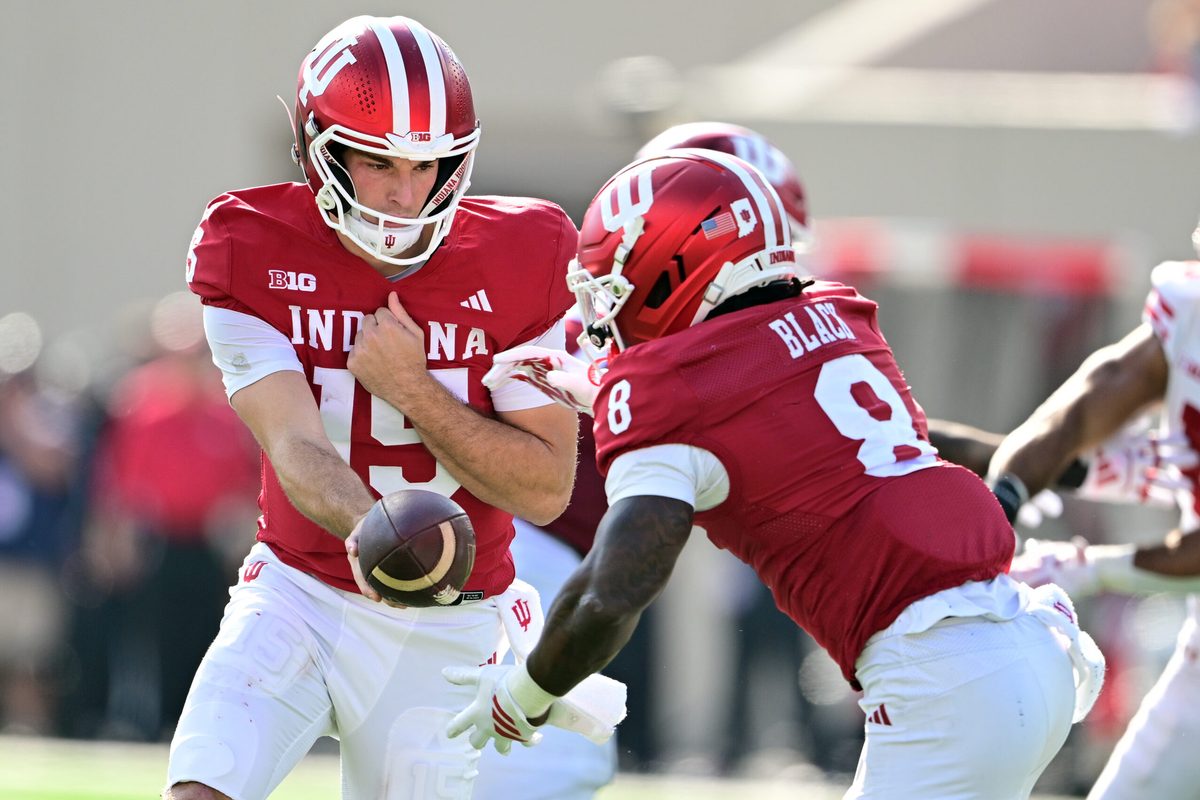 Nov 15, 2025; Bloomington, Indiana, USA;  Indiana Hoosiers quarterback Fernando Mendoza (15) hands the ball off to Indiana Hoosiers running back Kaelon Black (8) during the second half against the Wisconsin Badgers at Memorial Stadium. Mandatory Credit: Marc Lebryk-Imagn Images