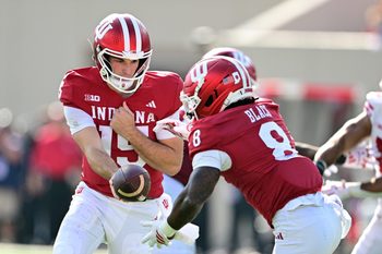 Nov 15, 2025; Bloomington, Indiana, USA;  Indiana Hoosiers quarterback Fernando Mendoza (15) hands the ball off to Indiana Hoosiers running back Kaelon Black (8) during the second half against the Wisconsin Badgers at Memorial Stadium. Mandatory Credit: Marc Lebryk-Imagn Images