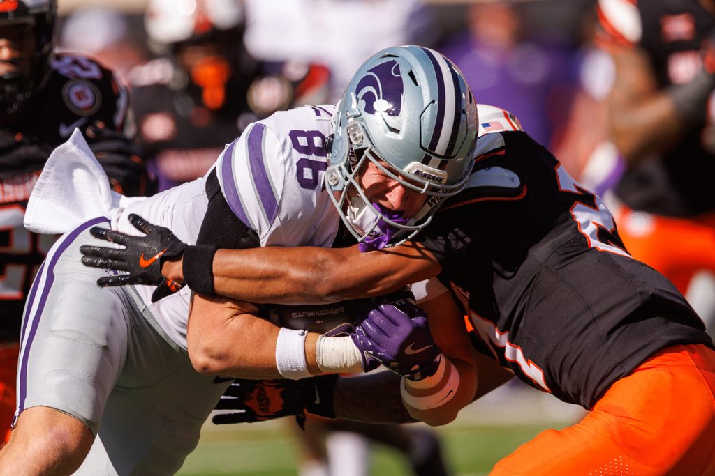 Nov 15, 2025; Stillwater, Oklahoma, USA; Kansas State Wildcats tight end Garrett Oakley (86) is hit by Oklahoma State Cowboys cornerback Carrington Pierce (20) during the first half at Boone Pickens Stadium. Mandatory Credit: William Purnell-Imagn Images