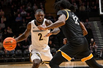 Nov 15, 2025; Nashville, Tennessee, USA;  Vanderbilt Commodores guard Duke Miles (2) drives to the basket past Arkansas-Pine Bluff Golden Lions guard Quion Williams (13) during the first half at Memorial Gymnasium. Mandatory Credit: Steve Roberts-Imagn Images