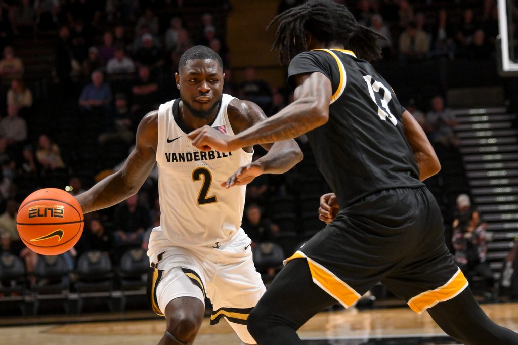 Nov 15, 2025; Nashville, Tennessee, USA; Vanderbilt Commodores guard Duke Miles (2) drives to the basket past Arkansas-Pine Bluff Golden Lions guard Quion Williams (13) during the first half at Memorial Gymnasium. Mandatory Credit: Steve Roberts-Imagn Images
