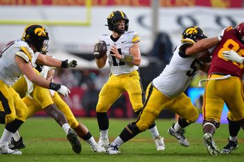 Nov 15, 2025; Los Angeles, California, USA; Iowa Hawkeyes quarterback Mark Gronowski (11) drops back to pass against the Southern California Trojans during the second half at the Los Angeles Memorial Coliseum. Mandatory Credit: Gary A. Vasquez-Imagn Images