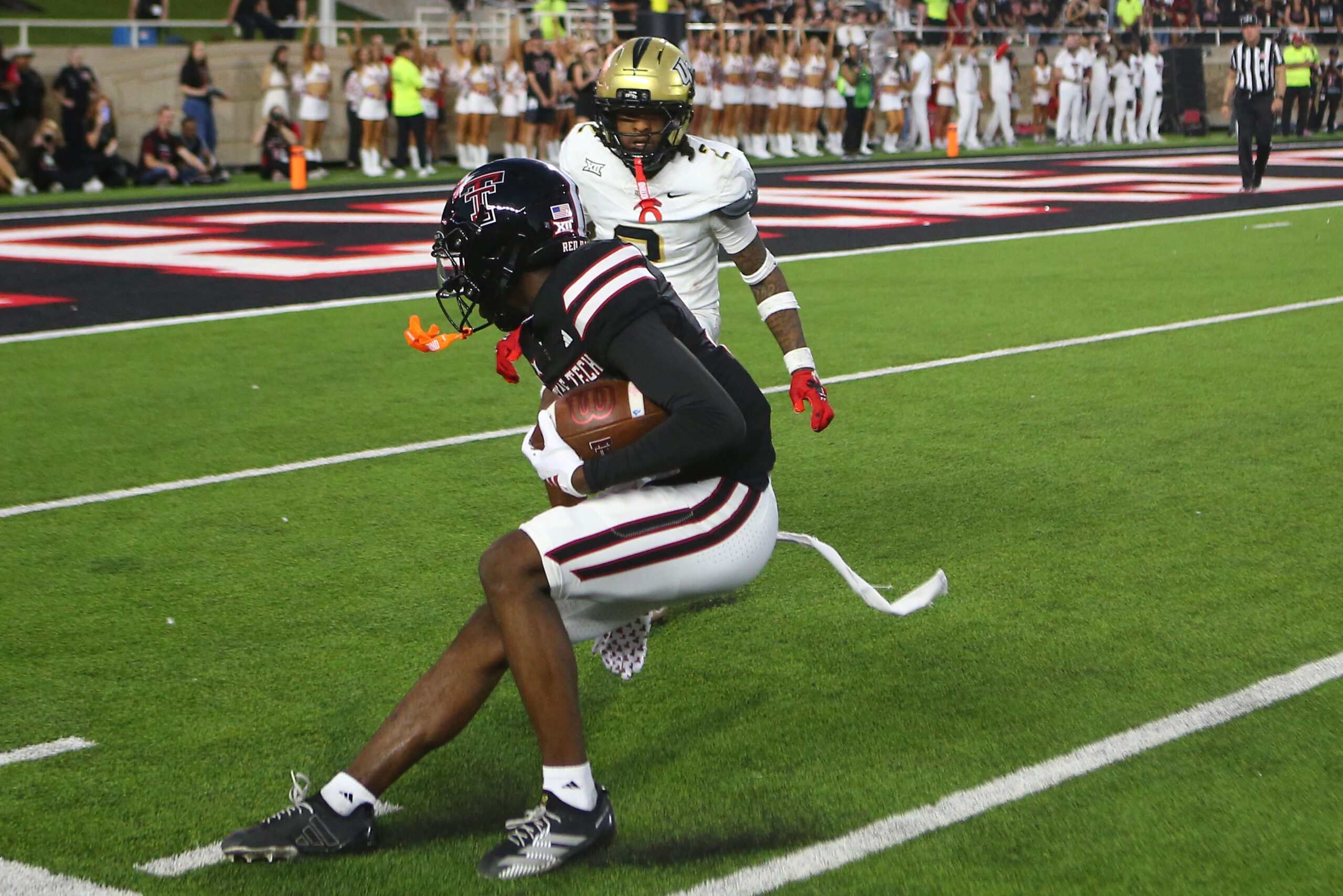 Nov 15, 2025; Lubbock, Texas, USA;  Texas Tech Red Raiders wide receiver Tristian Gentry (21) makes a catch against Central Florida Knights defensive safety Phillip Dunnam (2) in the second half at Jones AT&T Stadium. Mandatory Credit: Michael C. Johnson-Imagn Images
