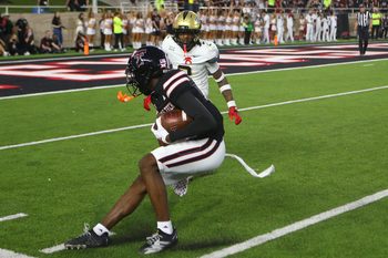 Nov 15, 2025; Lubbock, Texas, USA;  Texas Tech Red Raiders wide receiver Tristian Gentry (21) makes a catch against Central Florida Knights defensive safety Phillip Dunnam (2) in the second half at Jones AT&T Stadium. Mandatory Credit: Michael C. Johnson-Imagn Images