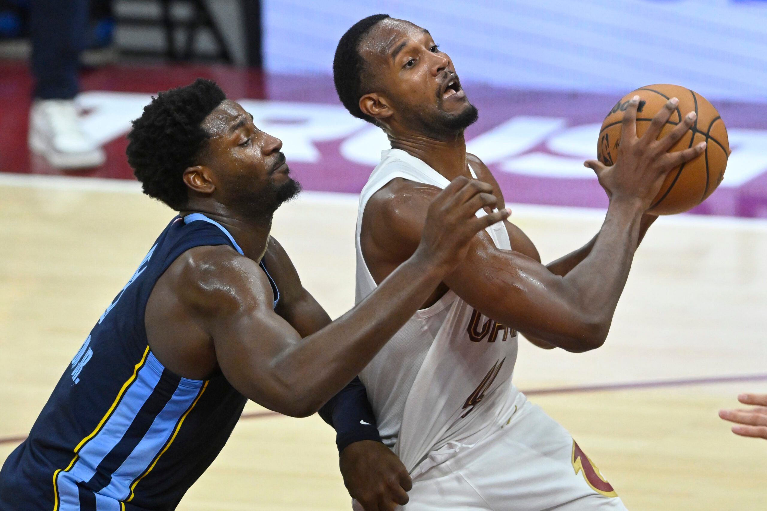 Nov 15, 2025; Cleveland, Ohio, USA; Cleveland Cavaliers center Evan Mobley (4) drives to the basket beside Memphis Grizzlies forward Jaren Jackson Jr. (8) in the fourth quarter at Rocket Arena. Mandatory Credit: David Richard-Imagn Images
