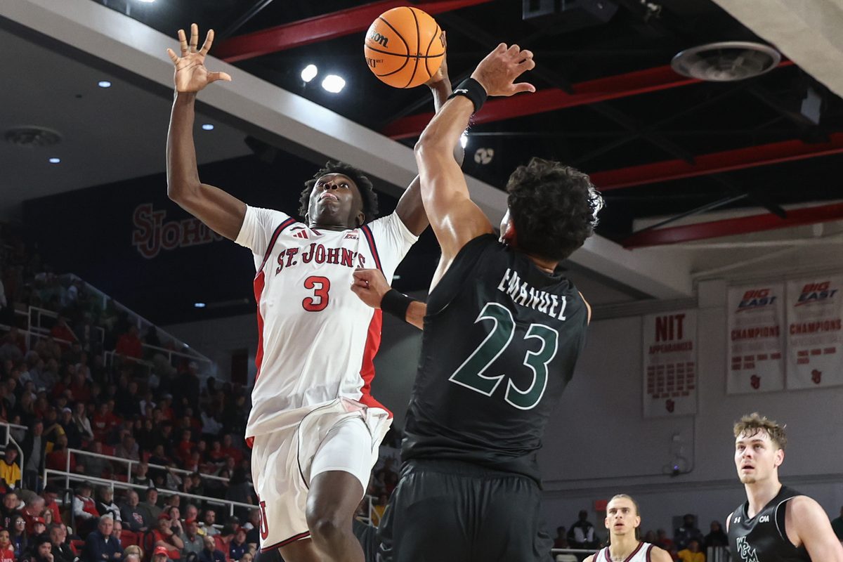Nov 15, 2025; Queens, New York, USA; St. John's Red Storm guard Joson Sanon (3) looks to drive past William & Mary Tribe forward Jo'El Emanuel (23) in the second half at Carnesecca Arena. Mandatory Credit: Wendell Cruz-Imagn Images