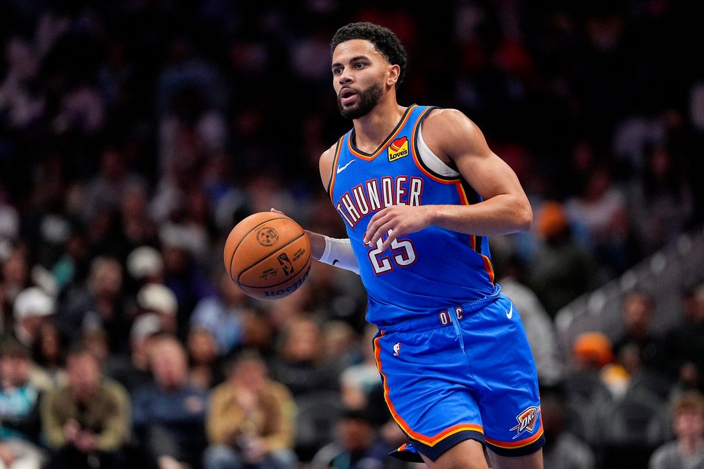 Nov 15, 2025; Charlotte, North Carolina, USA; Oklahoma City Thunder guard Ajay Mitchell (25) brings the ball up court against the Charlotte Hornets during the second half at Spectrum Center. Mandatory Credit: Jim Dedmon-Imagn Images